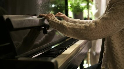 Interior. Woman's hands in white sweater open old vintage piano. Piano Keys Piano lesson, Pianist, Music. Cinematic 4k slow motion