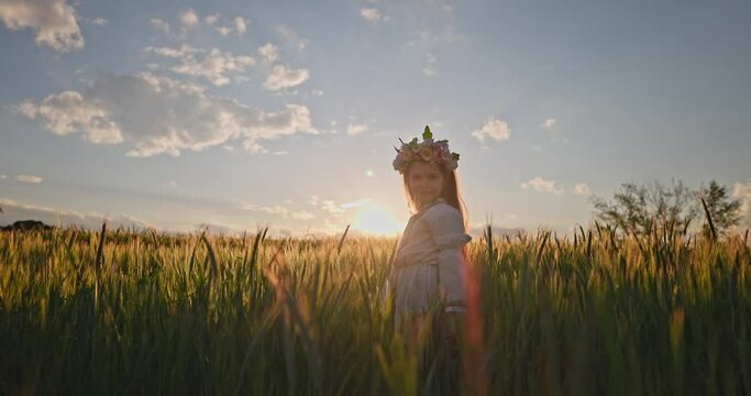 Wheat field at sunset and farmer woman bulgarian girl in ethnic folklore costume with bulgarian embroidery work in the meadow 4K video of Bulgaria nature