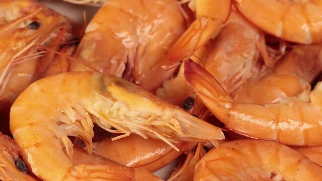 Shrimps on the plate. Fresh prawns, healthy seafood, close up, 4k footage.