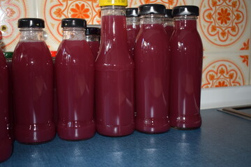 homemade red juice in reused bottles