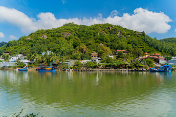 Fototapeta premium Houses on the river bank.The Kai River in Nha Trang in Vietnam. The urban landscape.