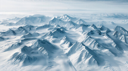 Aerial view of a snow-covered mountain range. - obrazy, fototapety, plakaty