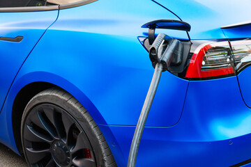 Charging an electric car with a charging cable.