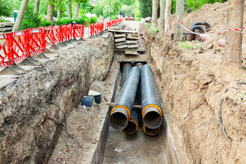 Laying new large diameter water pipes in the ground in the city.