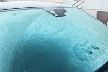 A Car Covered in Frost on a Cold Winter Morning.Patterns of ice crystals on the surface of the...