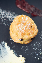 A beautiful gourmet selection of english afternoon tea cakes and scones served with organic cupcakes, tea and coffee, strawberry jam and clotted cream. traditional british food.