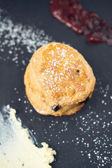 A beautiful gourmet scone served with tea and coffee, strawberry jam and clotted cream. traditional...