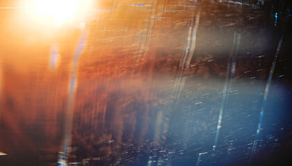 Fractured background. Blur lens flare. Dark shattered distressed dirty faded screen matrix texture with dust scratches smeared stains defocused orange blue white glow.