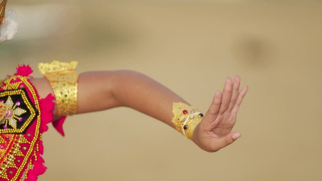 Close-up of balinese dancer's hand gesture in performance, artistic dance expression