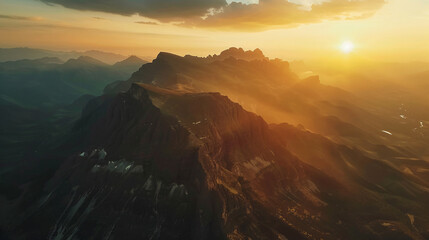 A breathtaking aerial view of a vast mountain range at sunrise.