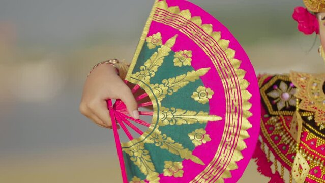 Traditional balinese dance fan in vibrant colors, cultural accessory or prop