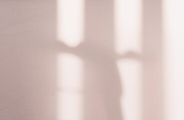 Beige Concrete texture wall background with light,leavs shadow,Empty  Studio Cement room with Sunlight reflect on peach colour paint,Backdrop for Spring,Summer product design presentation