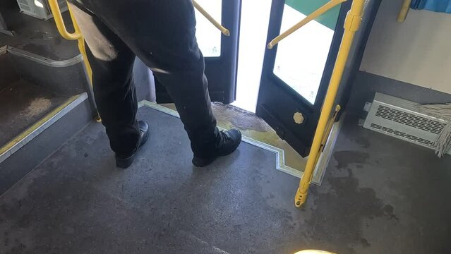 people getting off public transport at a bus stop during the daytime