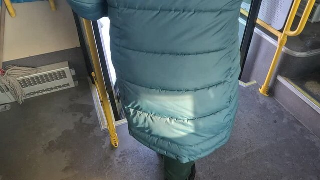 people getting off public transport at a bus stop during the daytime