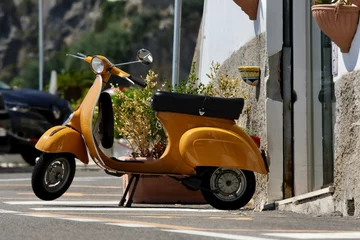 Foto op Plexiglas vintage scooter parked on the street © Jannat
