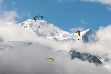 Three paragliders in flight above Mont Blanc (4807 meters a.s.l.) in the French Alps in summer, Chamonix, Haute Savoie, Auvergne Rhone Alpes, France