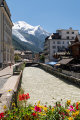 The Arve River, an alpine stream running through the popular ski resort, with Mont Blanc mountain in the background, Chamonix, Haute Savoie, Auvergne Rhone Alpes, France