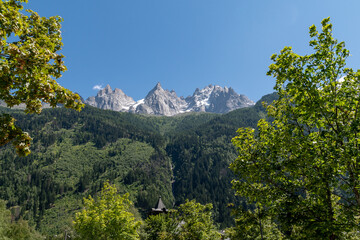 View of the Aiguilles of Chamonix ("Chamonix Needles"), a group of rocky ridges of the Mont Blanc massif, from the centre of the alpine town in summer, Haute Savoie, France