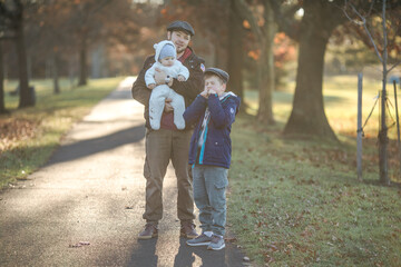 Heartwarming hugs little sons and his father in warm sun shins