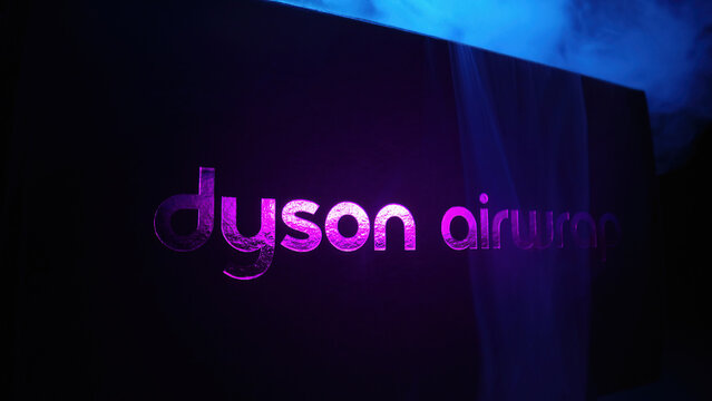 February 2024 - Prague, Czechia. Dyson Airwrap brand logo in neon and smoke. Popular multi-styler with various attachments.