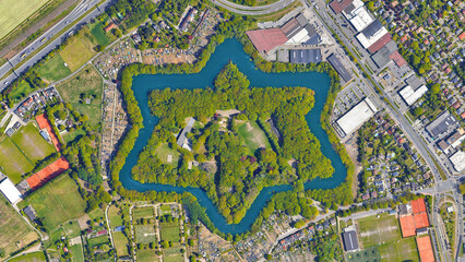 Fort Van Merksem, pentagon - star shaped historical defensive castle looking down aerial view from...