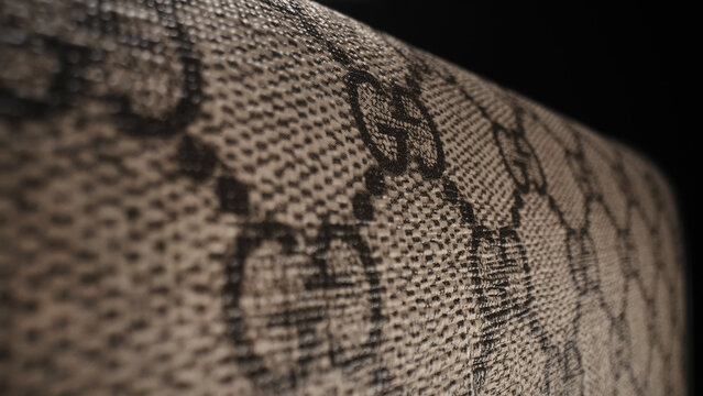 February 2024 - Milan, Italy. Gucci monogram background, brand label logo. Double G. Handbag pattern in canvas. Luxury fashion italian company.