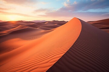 Fototapeta na wymiar Undulating dunes in a desert at sunset, casting long dramatic shadows