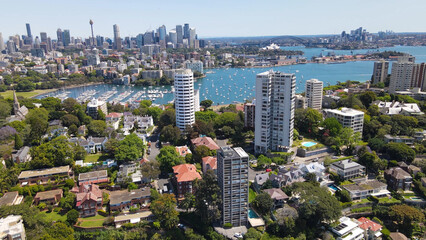 Aerial drone view above the harbourside suburb of Darling Point looking toward Sydney Harbour and Sydney City on a sunny day