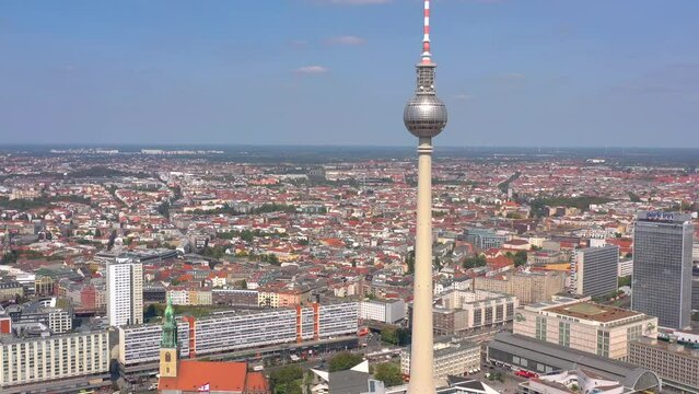 BERLIN, GERMANY - JUNE 16, 2023: Aerial drone view shot of TV Tower on the main square in city center from above at sunny day.