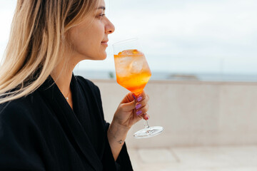 person drinking Aperol Spritz at the party