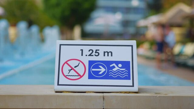 Safety sign with pool depth indication in 4k slow motion 120fps