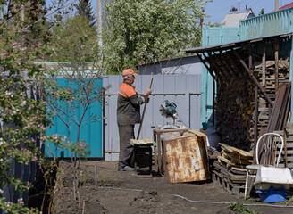 Close-up of a carpenter using a circular saw to cut a large board of wood