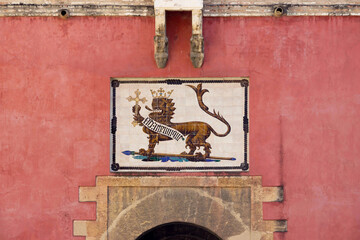 entrance gate at Alcazar royal palace in Seville, Spain - 744583427