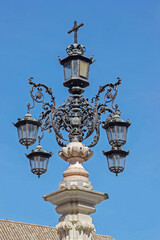 lamp in blue sky at Cathedral church in Seville, Spain  - 744583666