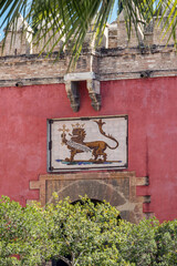 entrance gate at Alcazar royal palace in Seville, Spain - 744584008