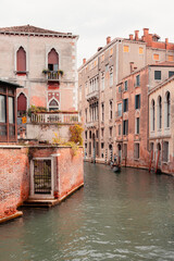 Venice quiet street crossed by a gondola