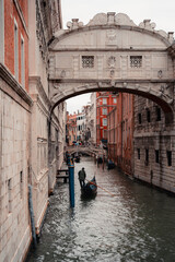 Venice lonely gondola beneath the Bridge of Sighs