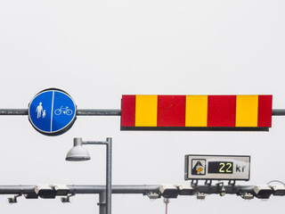 Pedestrian and Cyclist Signage Next to a Red and Yellow Barrier in Gothenburg, Sweden, on a Cloudy...
