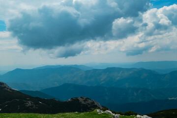 Naklejka premium On top of Feistritzer Spitze (Hochpetzen) with panoramic view of majestic mountain peaks Karawanks and Julian Alps, Carinthia, border Austria Slovenia. Hiking trail Petzen, Bleiburg, Völkermarkt
