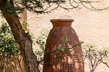 Ceramic clay pot with an ornament in the garden in UAE