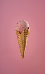 Strawberry Ice Cream in a Waffle Cone on a Pink Background