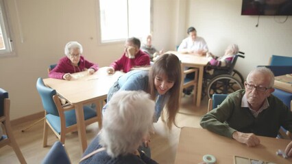 granddaughter visiting her grandparents in the nursing home giving them a big hug showing them her affection