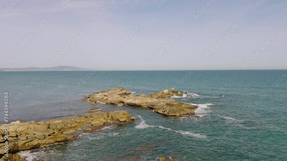 Wall mural Province of Castellon. Rocks and turquoise sea with waves. Favorite place for active walks. Oropesa del Mar 