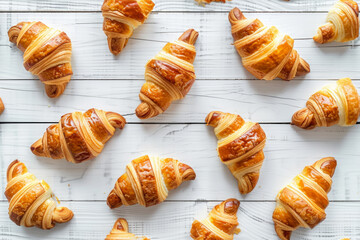 Delicious croissants on a white wooden background. Flat lay shot.