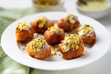 Pistachio Cream Stuffed Fritelle on Elegant White Plate