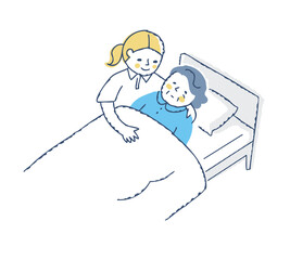 ベッドに寝ているシニア女性と介護している女性
