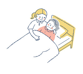 ベッドに寝ているシニア女性と介護している女性