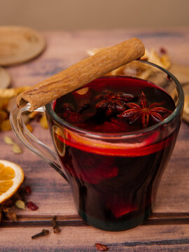 mug with mulled wine on wooden background