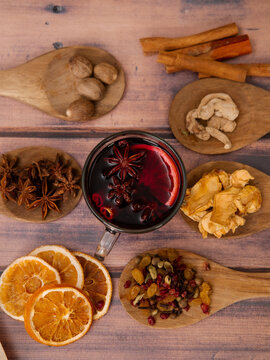 mug with mulled wine on wooden background