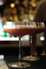 gin-containing cocktail served in a thin-stemmed cocktail glass indoors